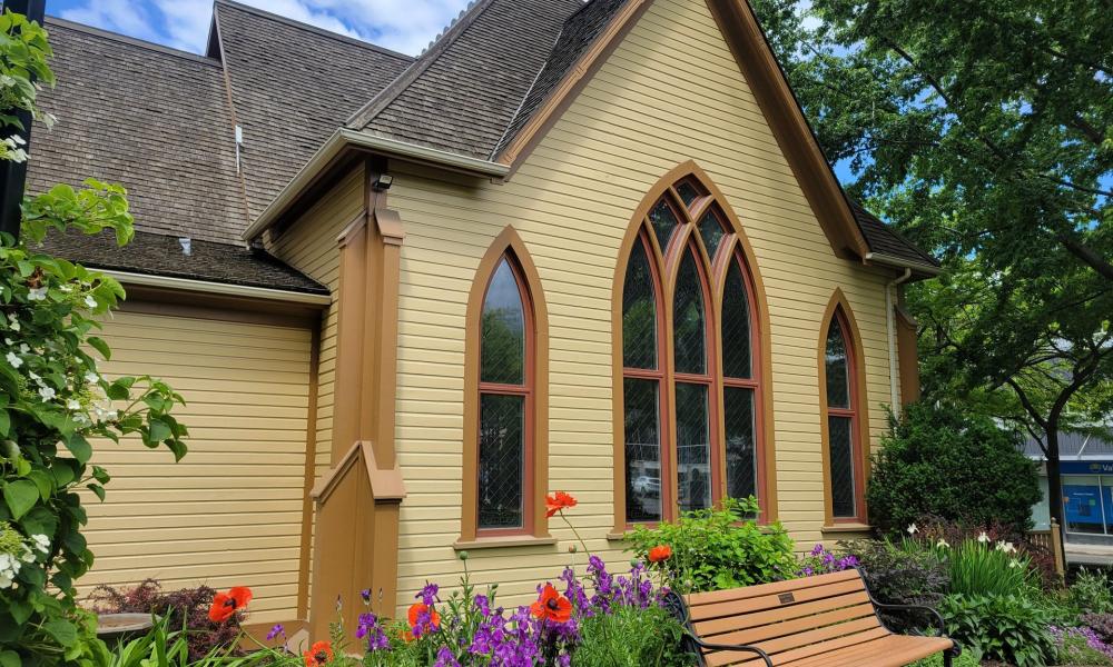 yellow church with stained glass windows