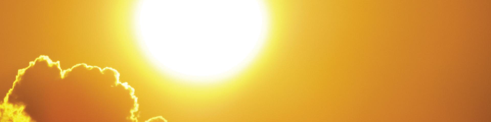 summer sun with yellow sky and clouds