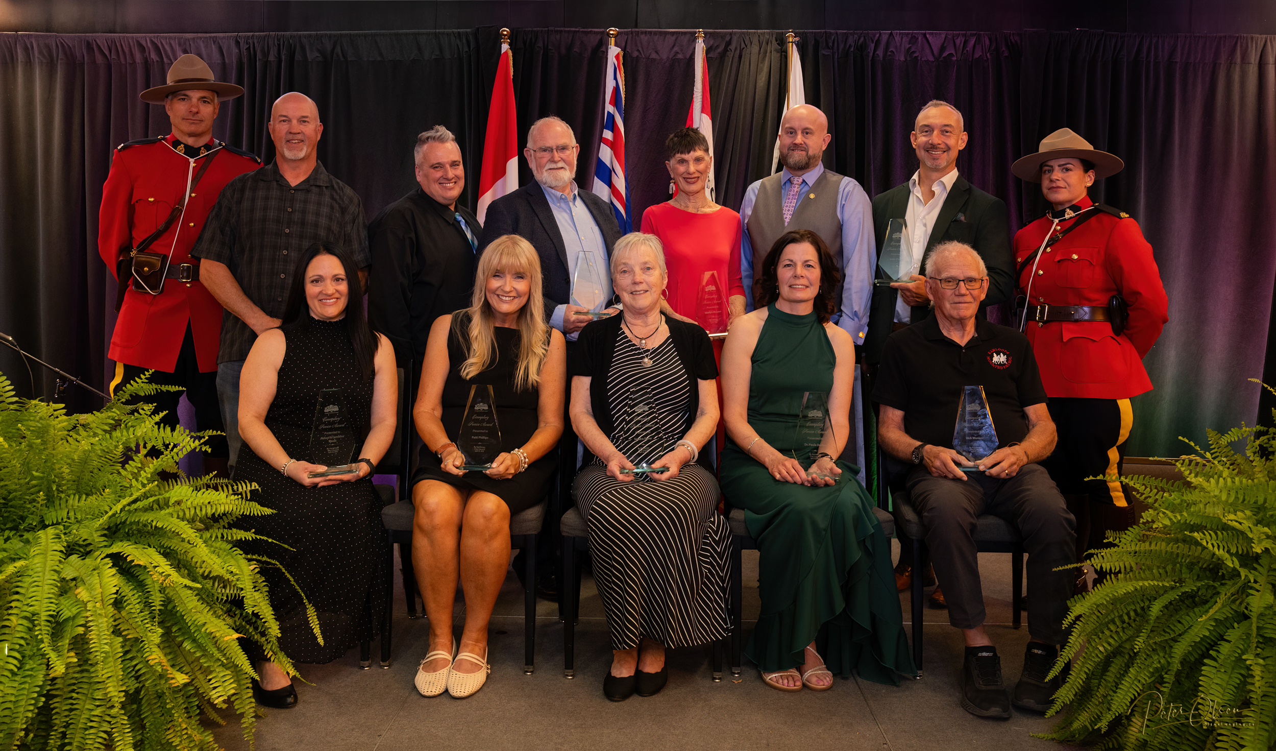 Group photograph of award winners holding their awards