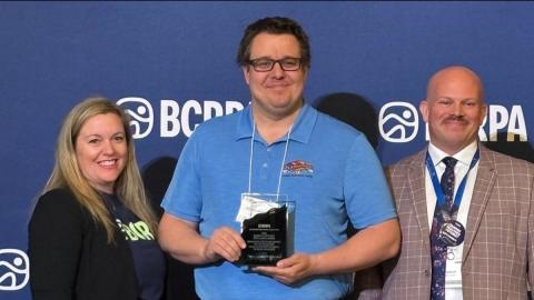 award recipients in front of a blue wall
